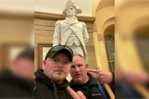 Rocky Mount police officers Jacob Fracker (left) and Thomas Robertson posing inside the Capitol in front of a statue